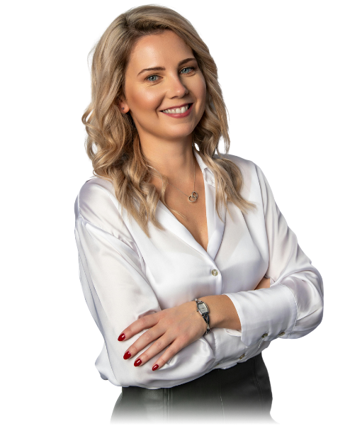 A smiling Kindora team member in a white blouse with her arms folded