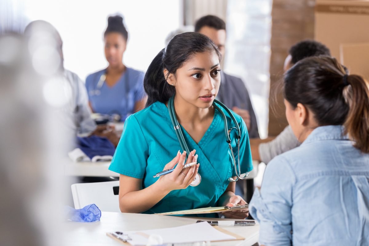 A community nurse caring for a client at home